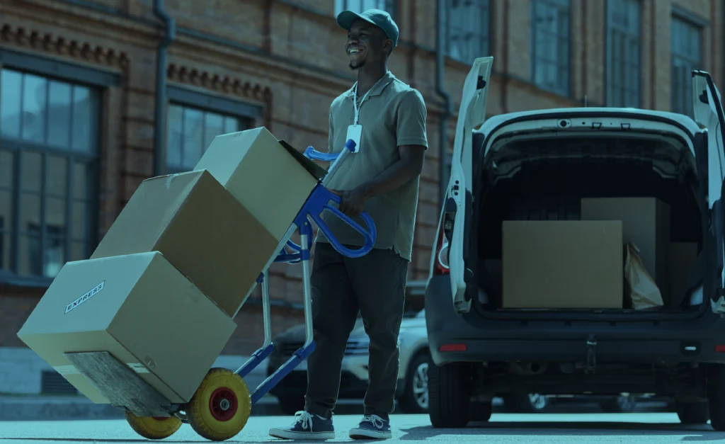 Worker loading boxes as part of an inventory management software system for efficient stock management and suggested ordering.